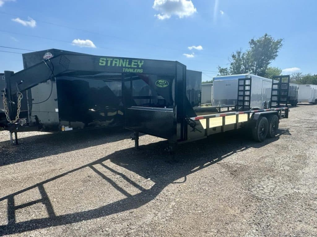 2026 Stanley Trailers 20' Gooseneck Utility Trailer in black, side view with stand-up ramps visible.
