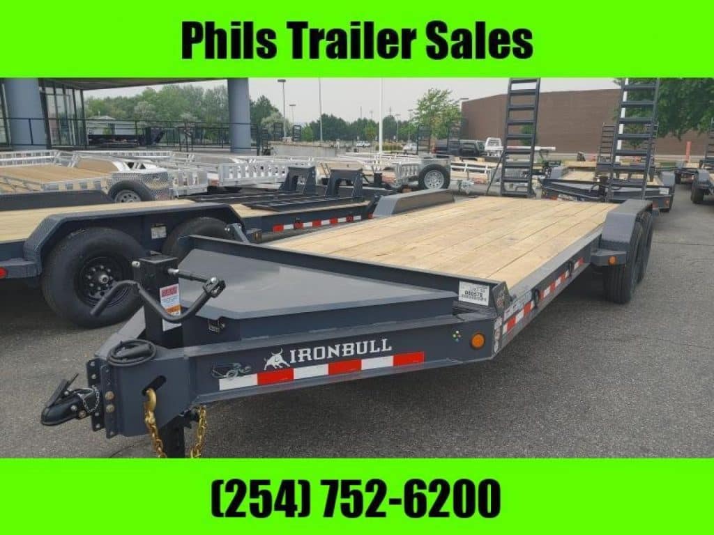 2026 Iron Bull 18' Equipment Trailer in gray, rear three-quarter view showing open deck and stand-up ramps.